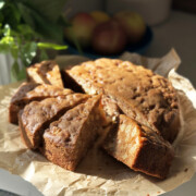 easy apple cake with olive oil, sliced on cake stand