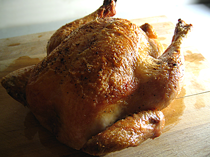 whole roast chicken on cutting board