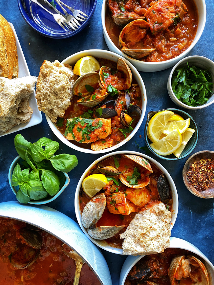 cioppino san francisco seafood stew with sourdough bread in bowls