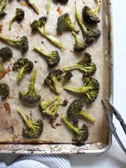 broccoli flrets spread out on baking sheet