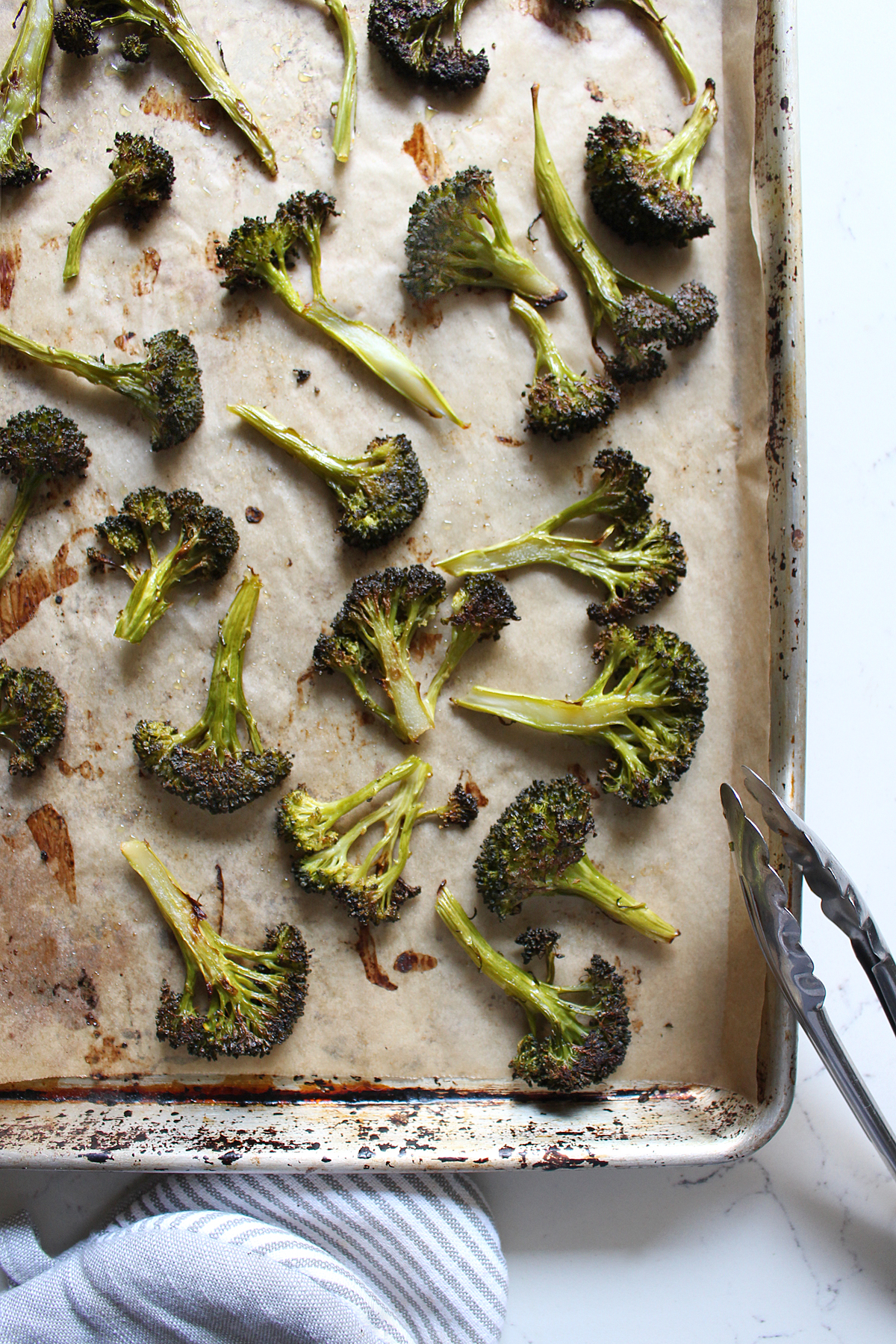 charred broccoli on baking sheet pan