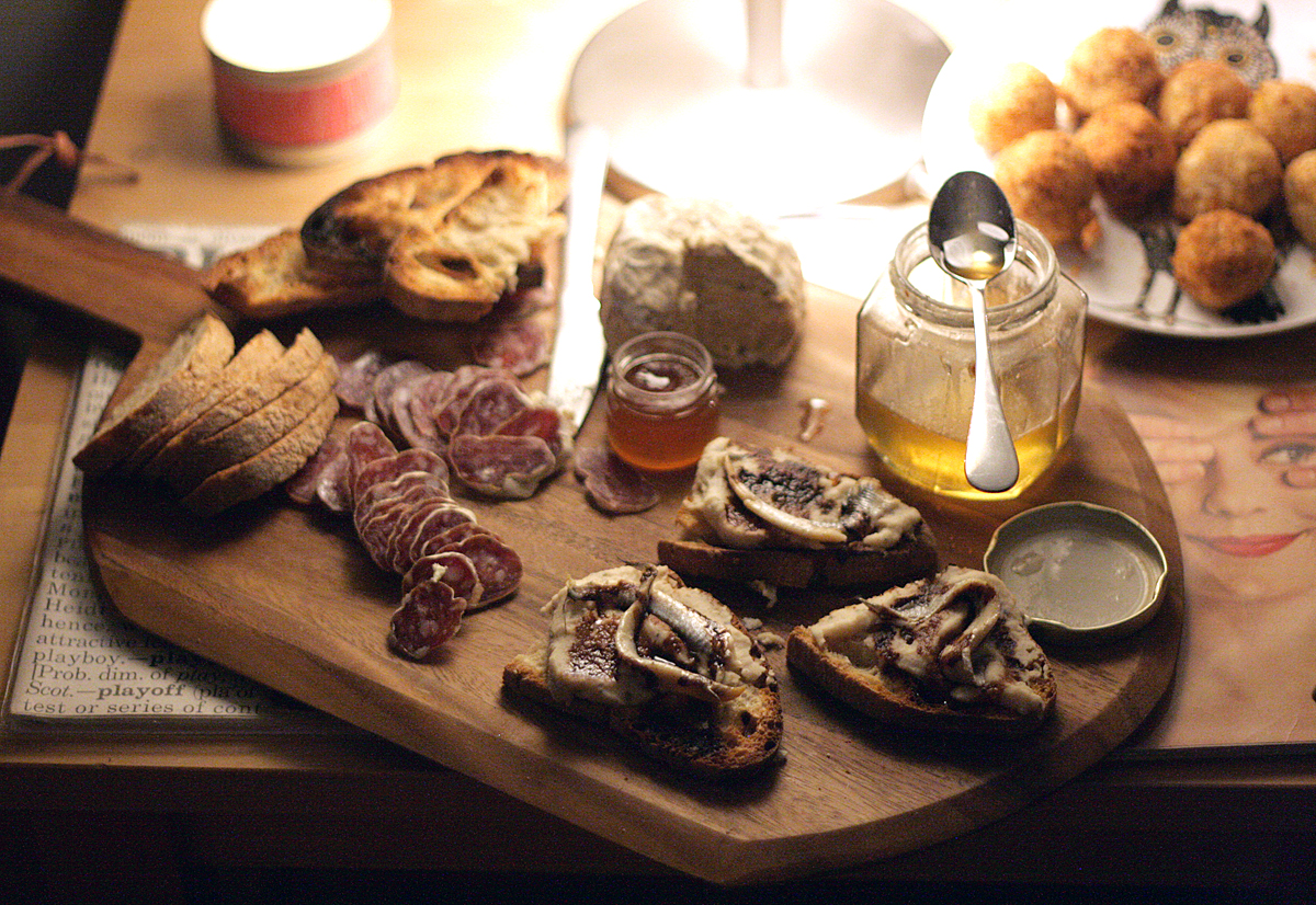 feast of seven fishes menu: sardine white bean bruschetta and charcuterie board