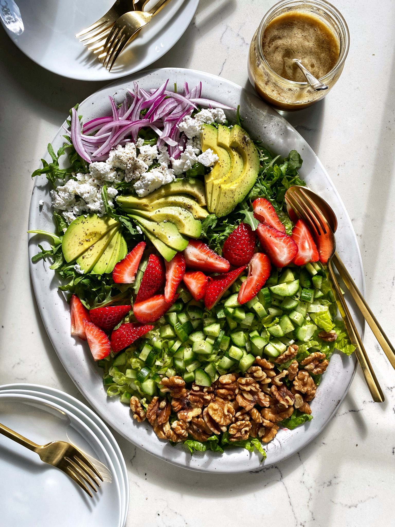 Strawberry salad with balsamic vinaigrette on platter