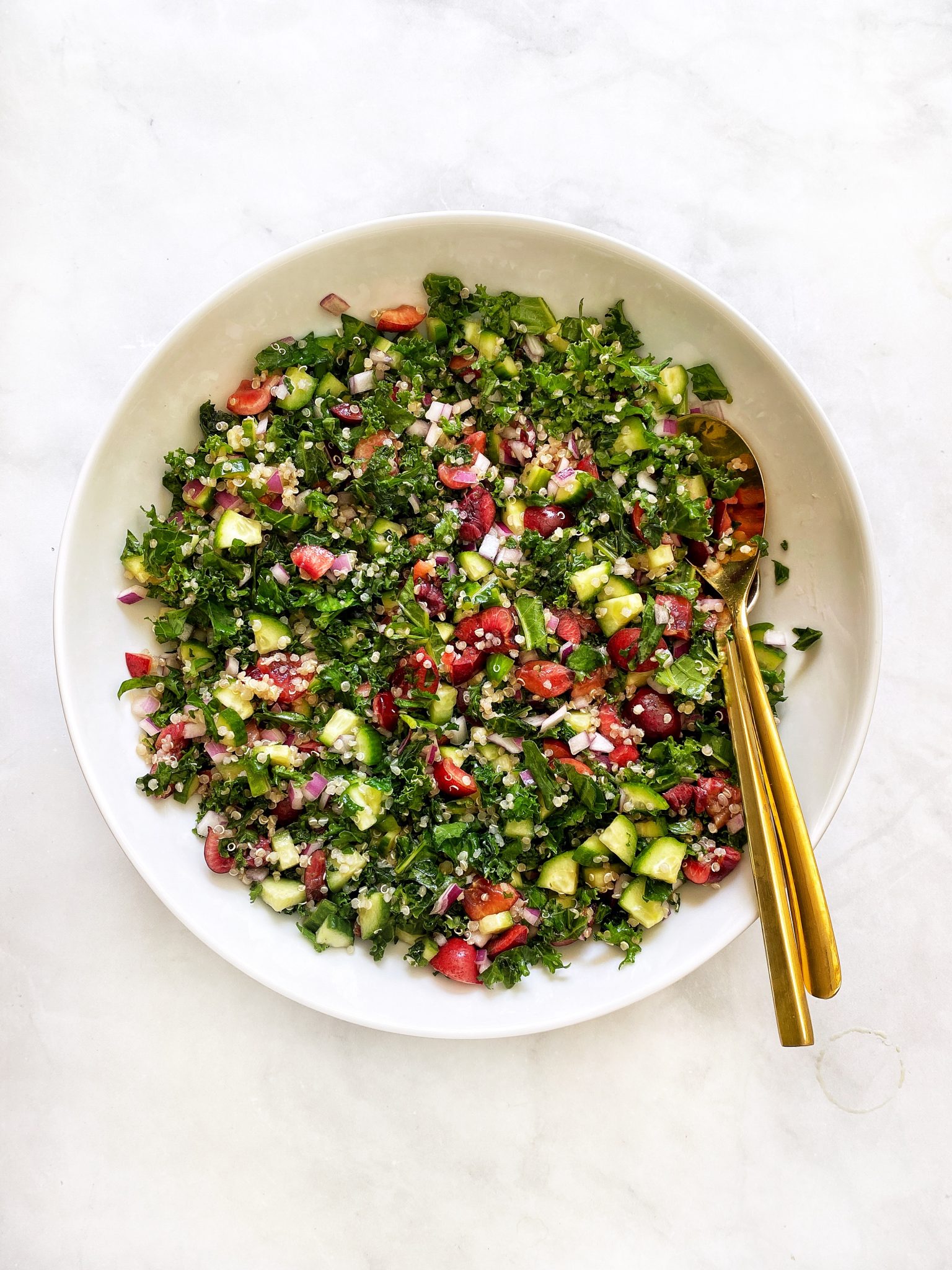 quinoa tabbouleh with kale and cherries, white bowl