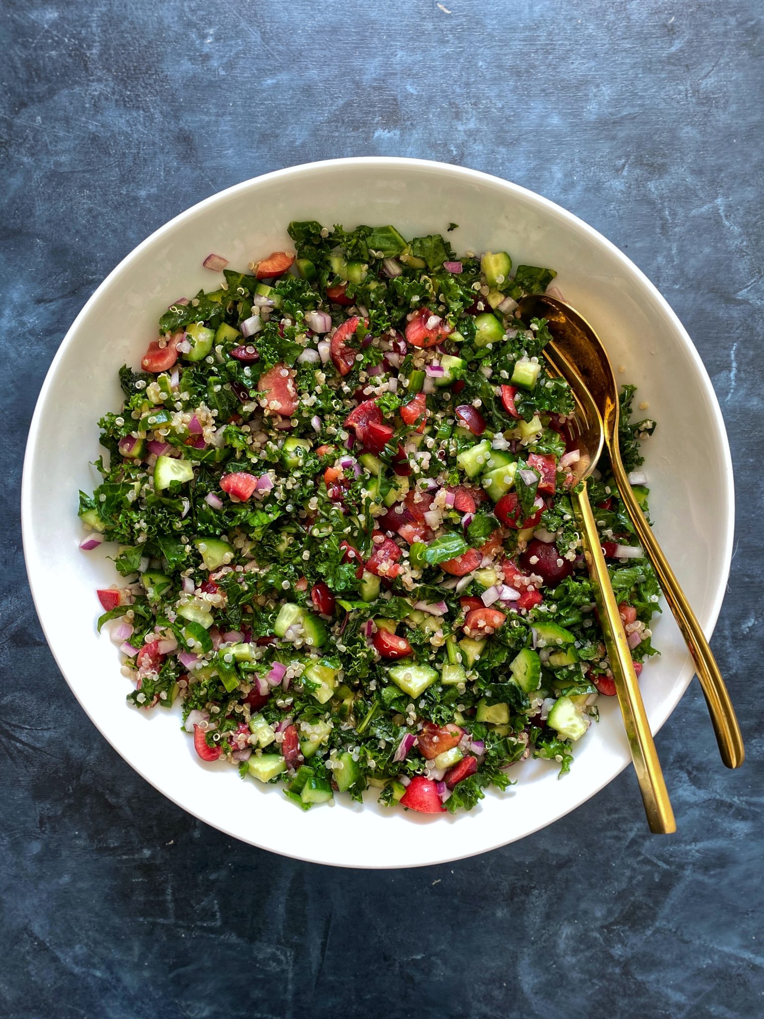 quinoa tabbouleh with kale and cherries, blue bowl