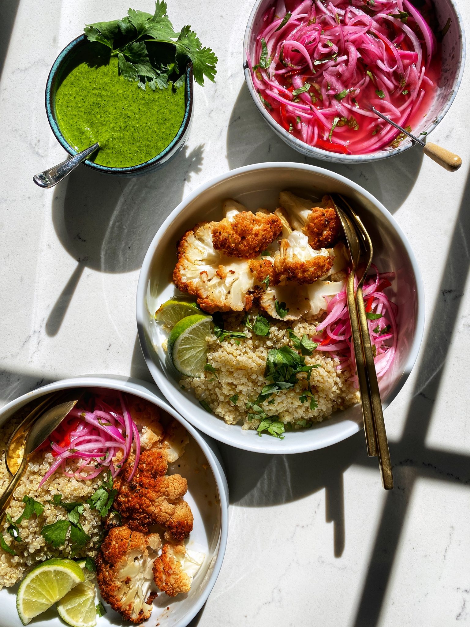 roasted cauliflower steaks with peruvian pollo a la brasa marinade and quinoa in bowl