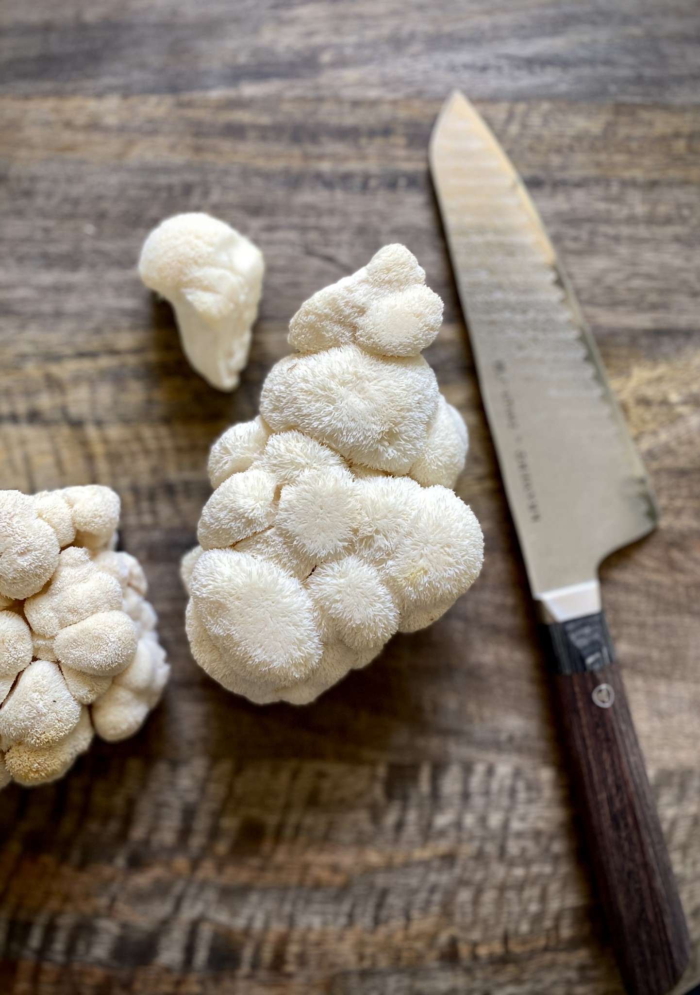 lion's mane mushrooms, wood cutting board with knife