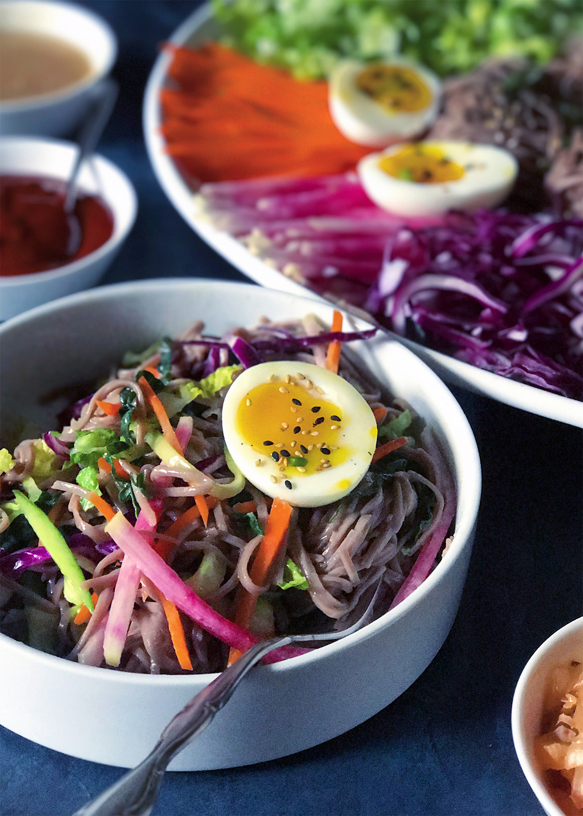 spicy soba salad with boiled egg in bowl