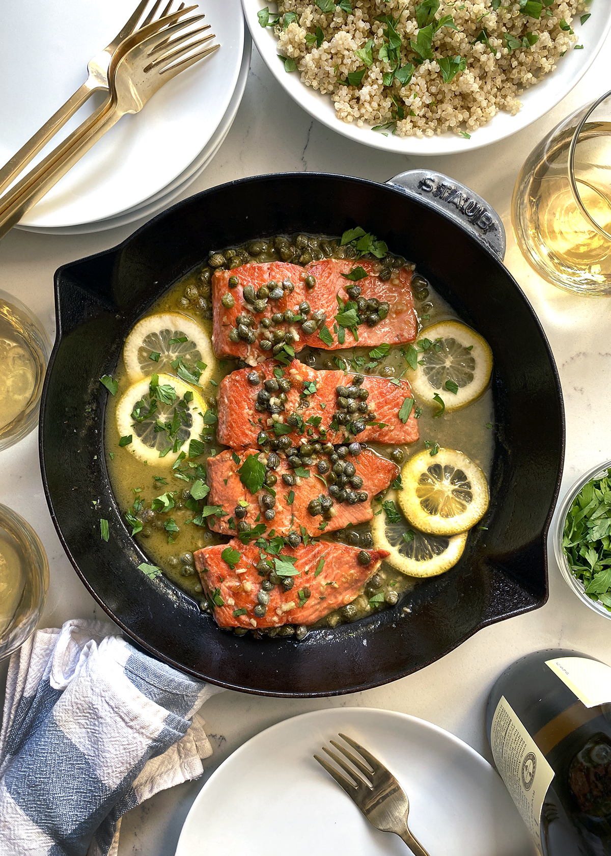 salmon piccata with lemon and capers in cast iron skillet