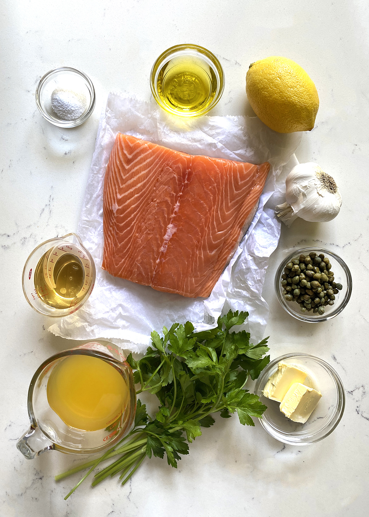 fresh salmon and ingredients mise en place for salmon piccata