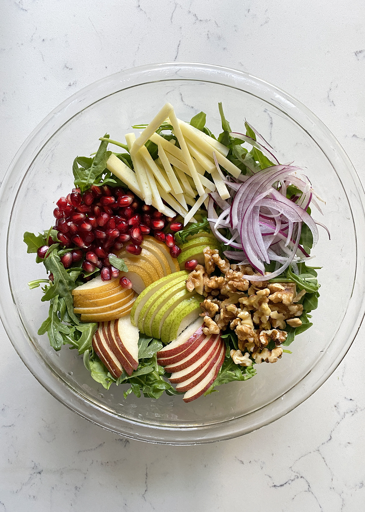 arugula pear salad in round bowl for chopped salad