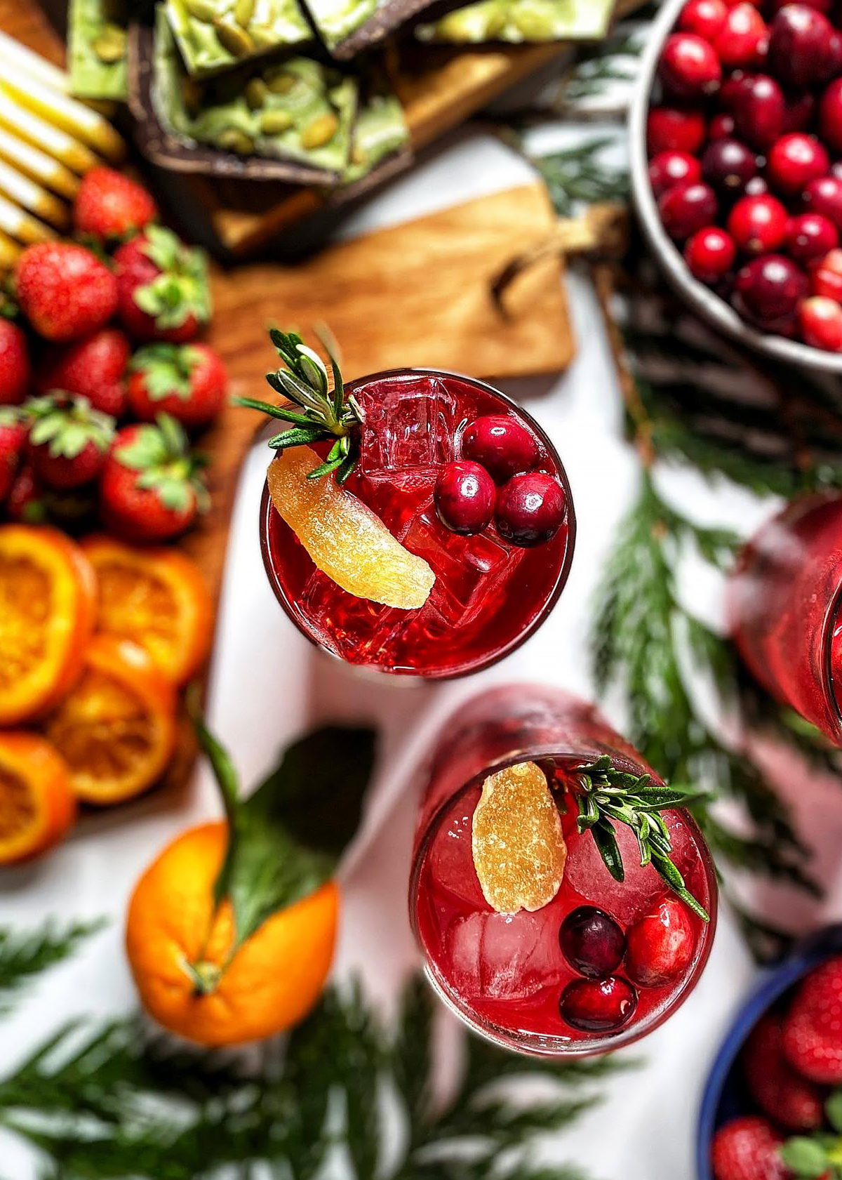 cranberry moscow mule with cranberries ginger and rosemary in glasses