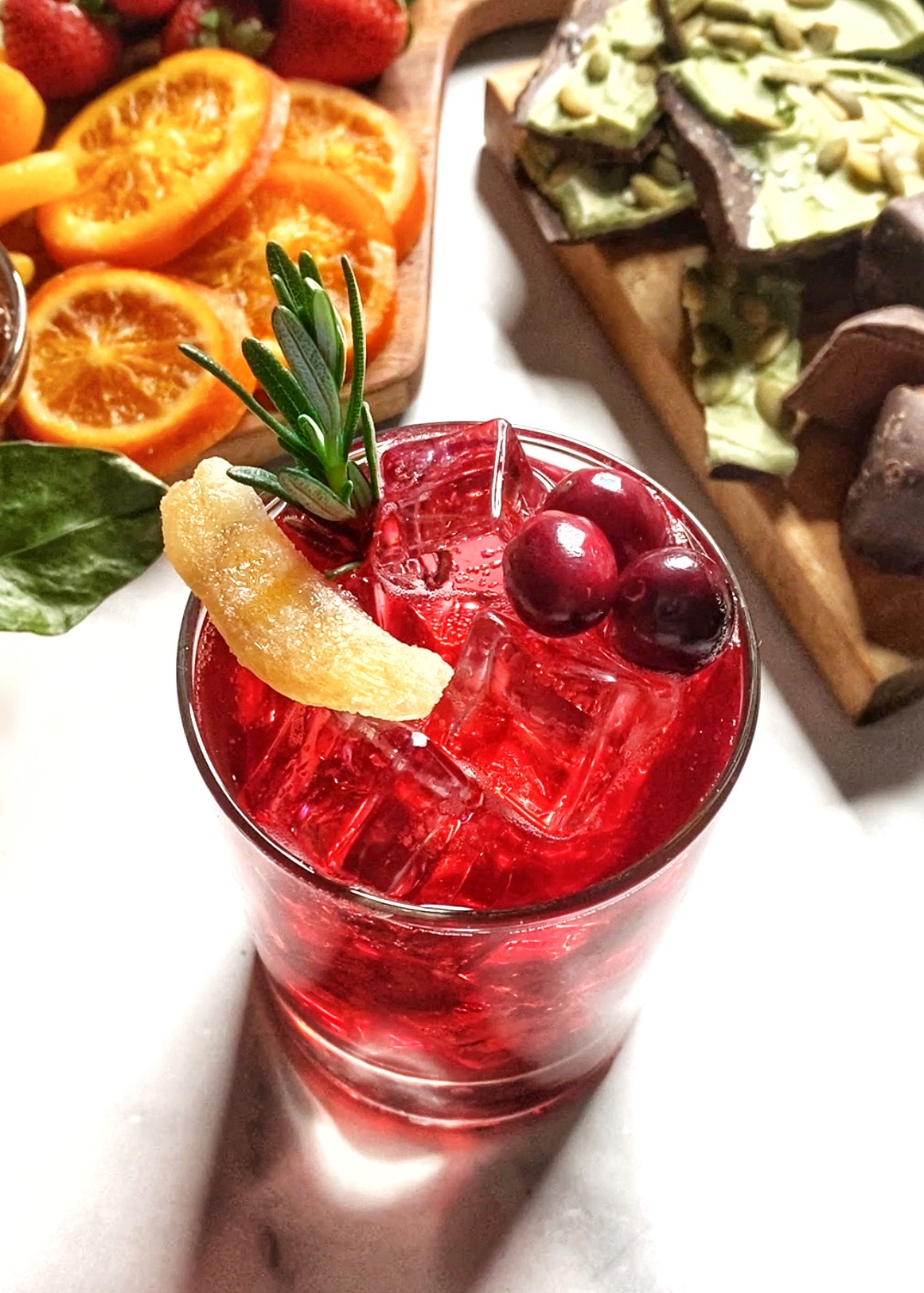 cranberry moscow mule with cranberries ginger and rosemary in glass