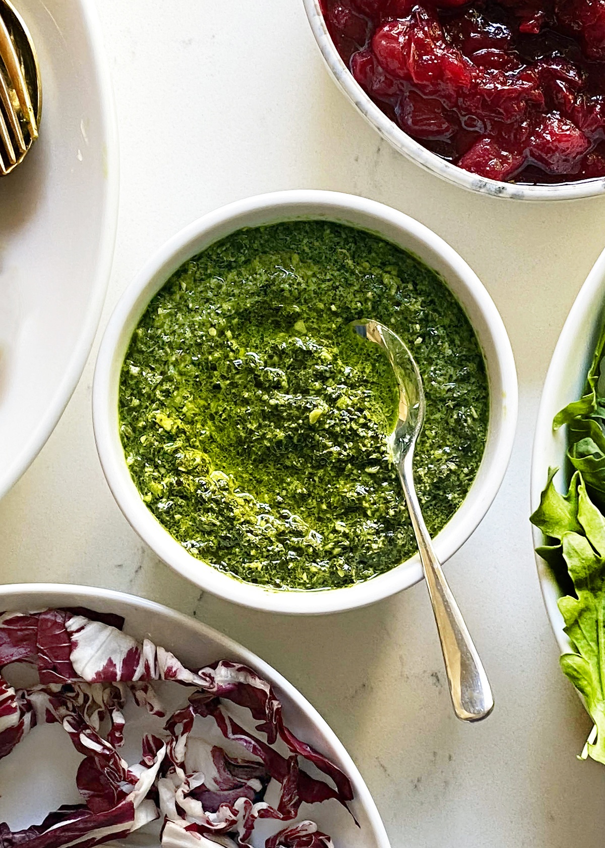 kale pesto in bowl on white table background