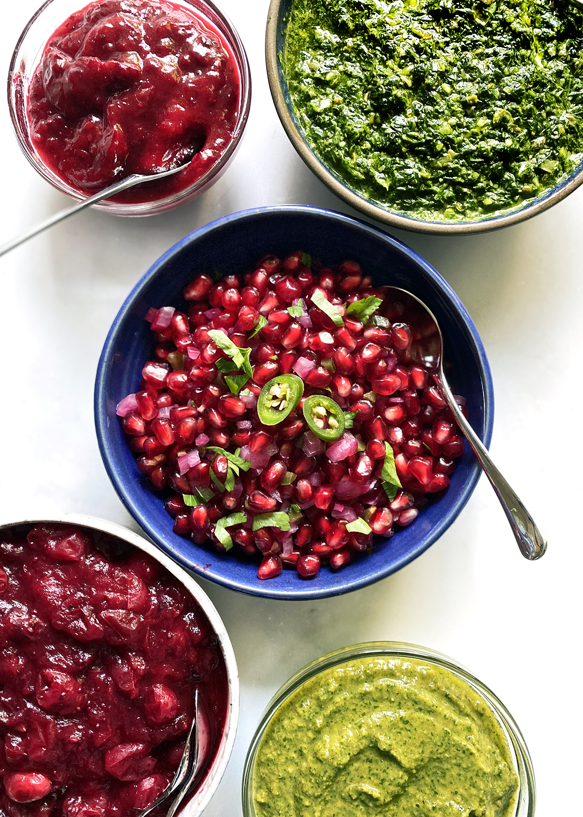 spicy pomegranate salsa in bowl with other sauces