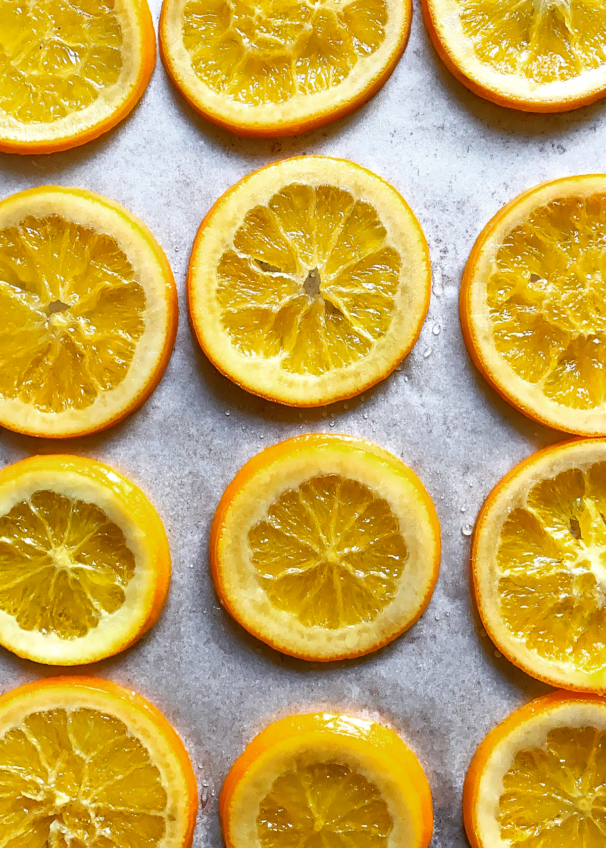 candied orange slices drying on baking sheet