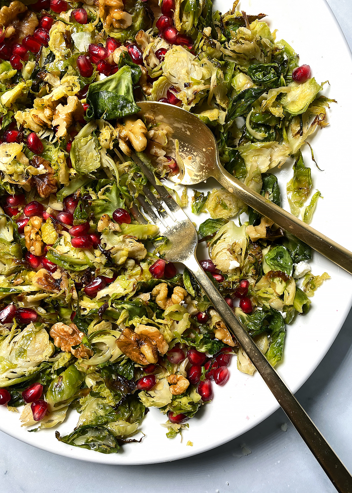 shredded brussels sprouts salad with pomegranate and walnuts