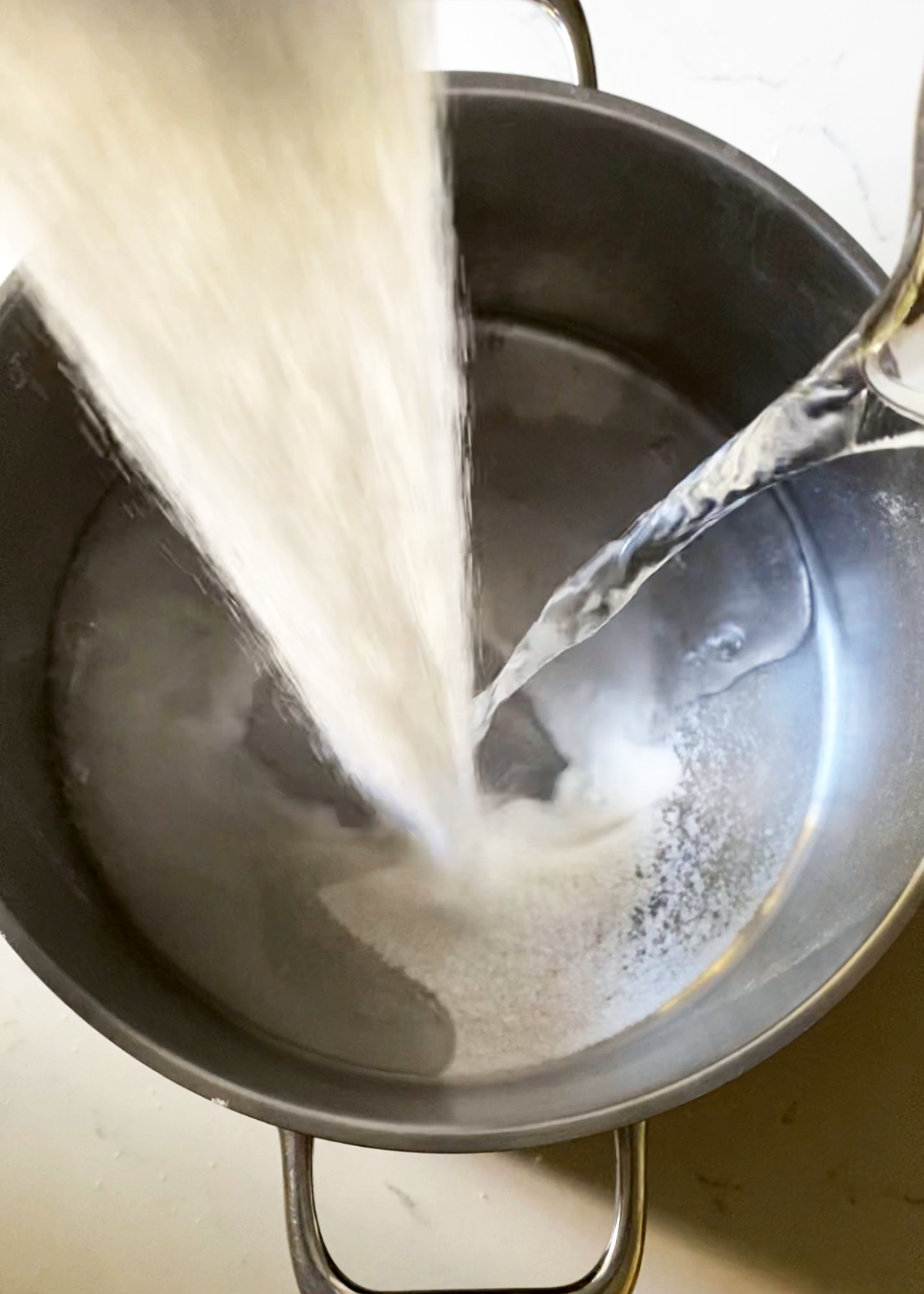 sugar and water-pouring into pot to make simple syrup