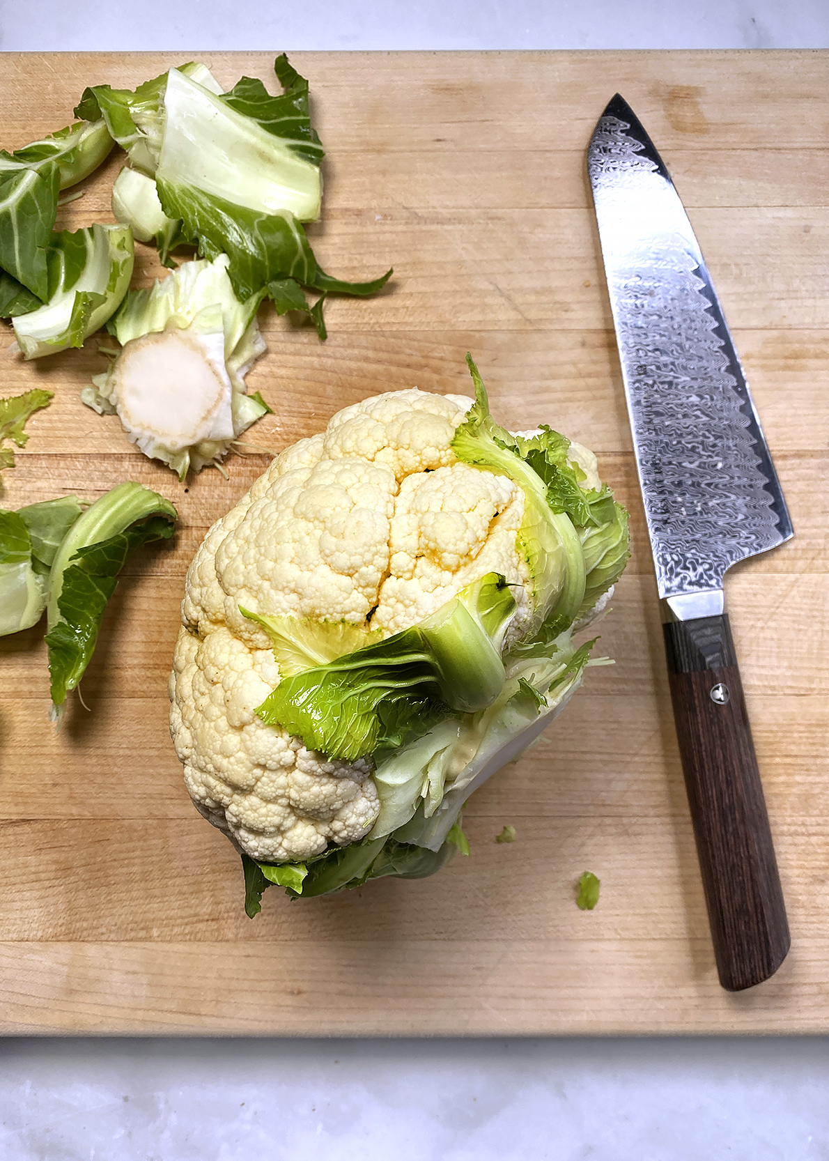 whole head of cauliflower being prepped