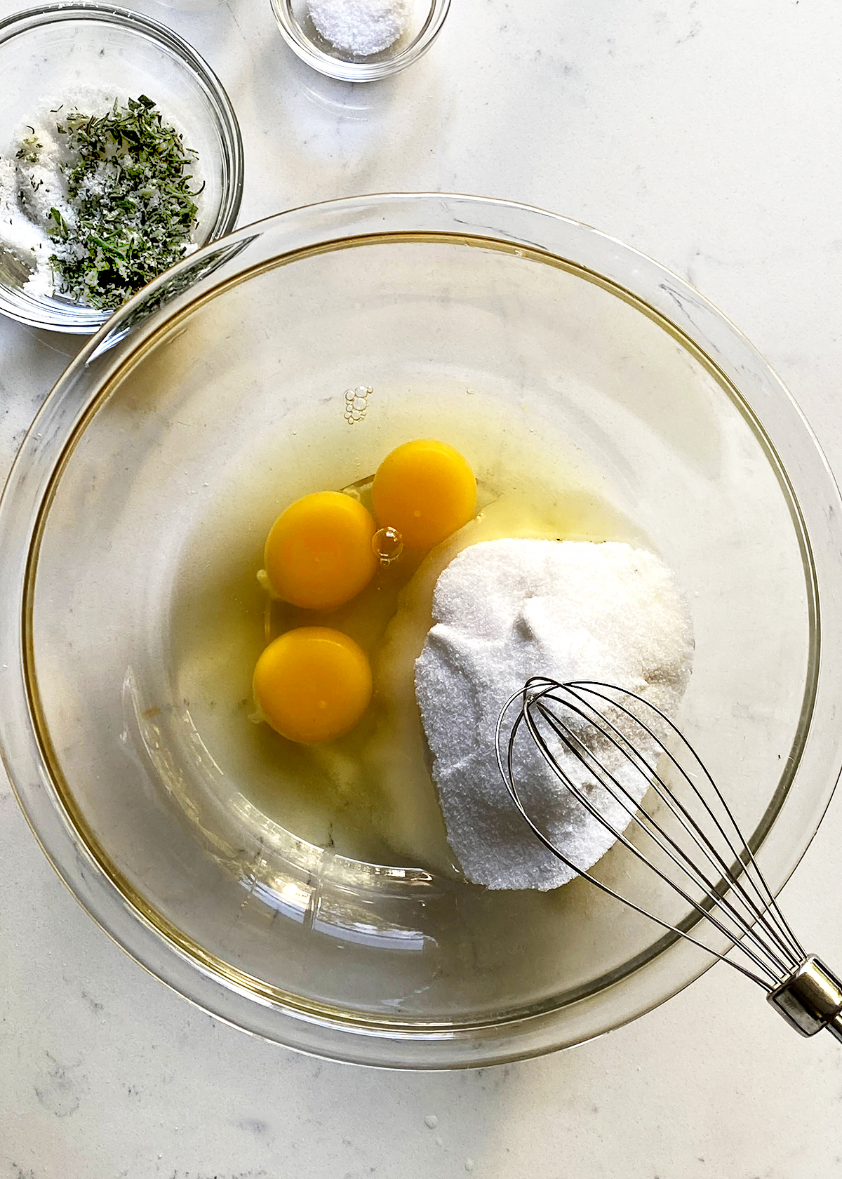beating eggs and sugar in mixing bowl