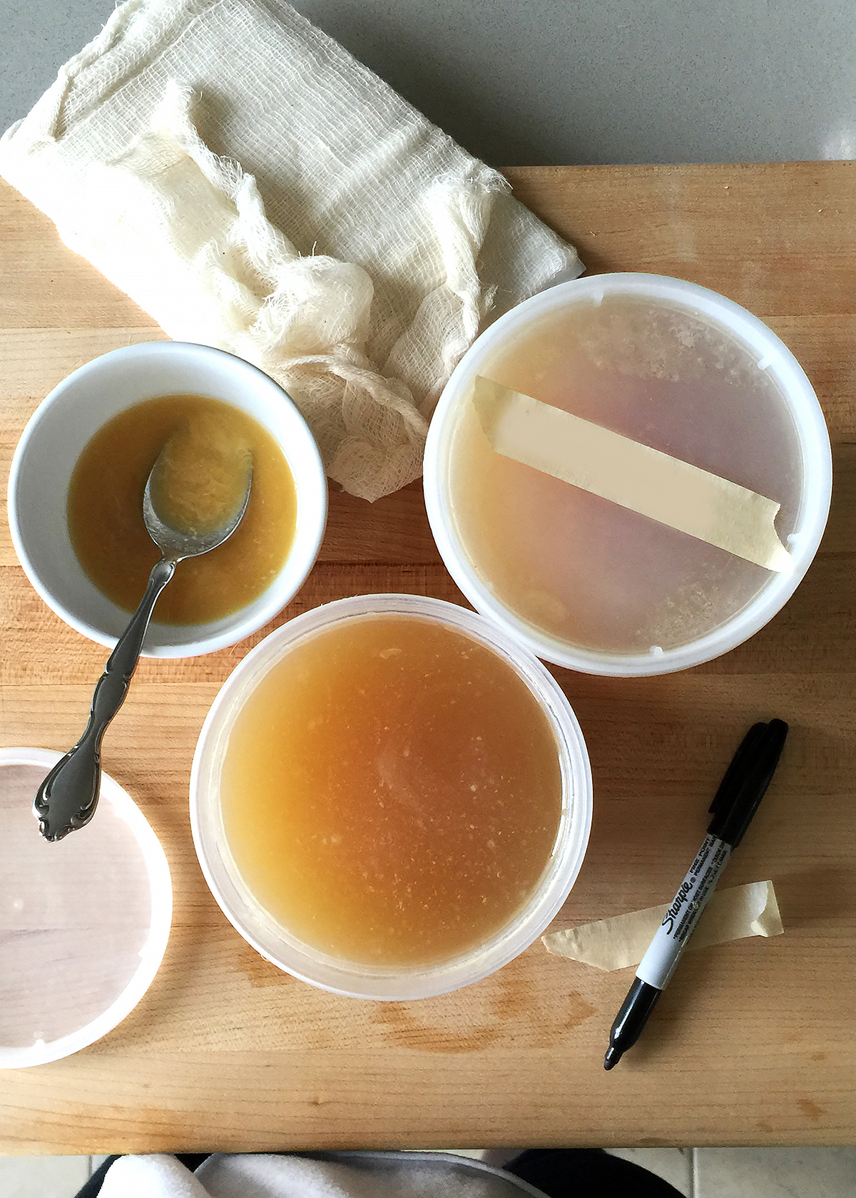 chicken bone broth in plastic deli cups for storage