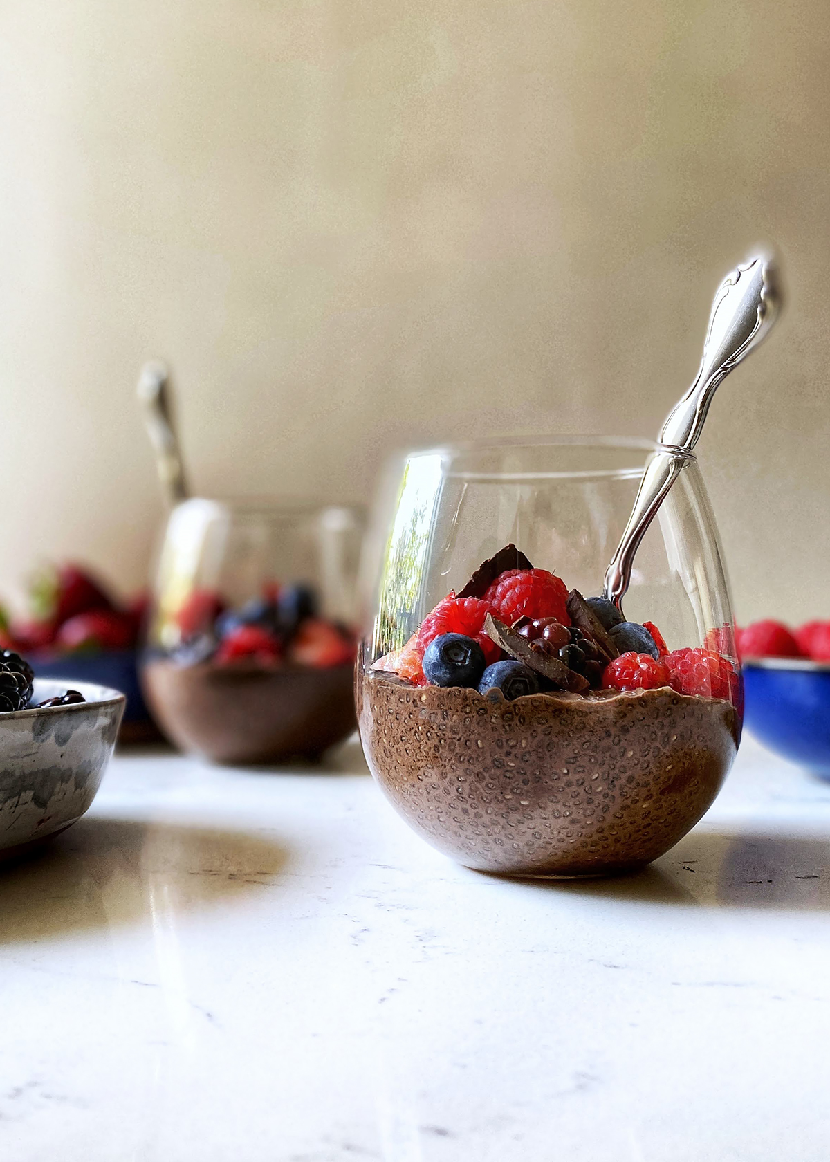 chocolate chia pudding in bowls with fresh berries