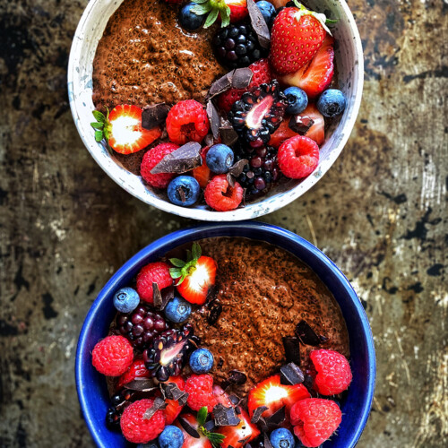chocolate chia pudding in bowls with fresh berries