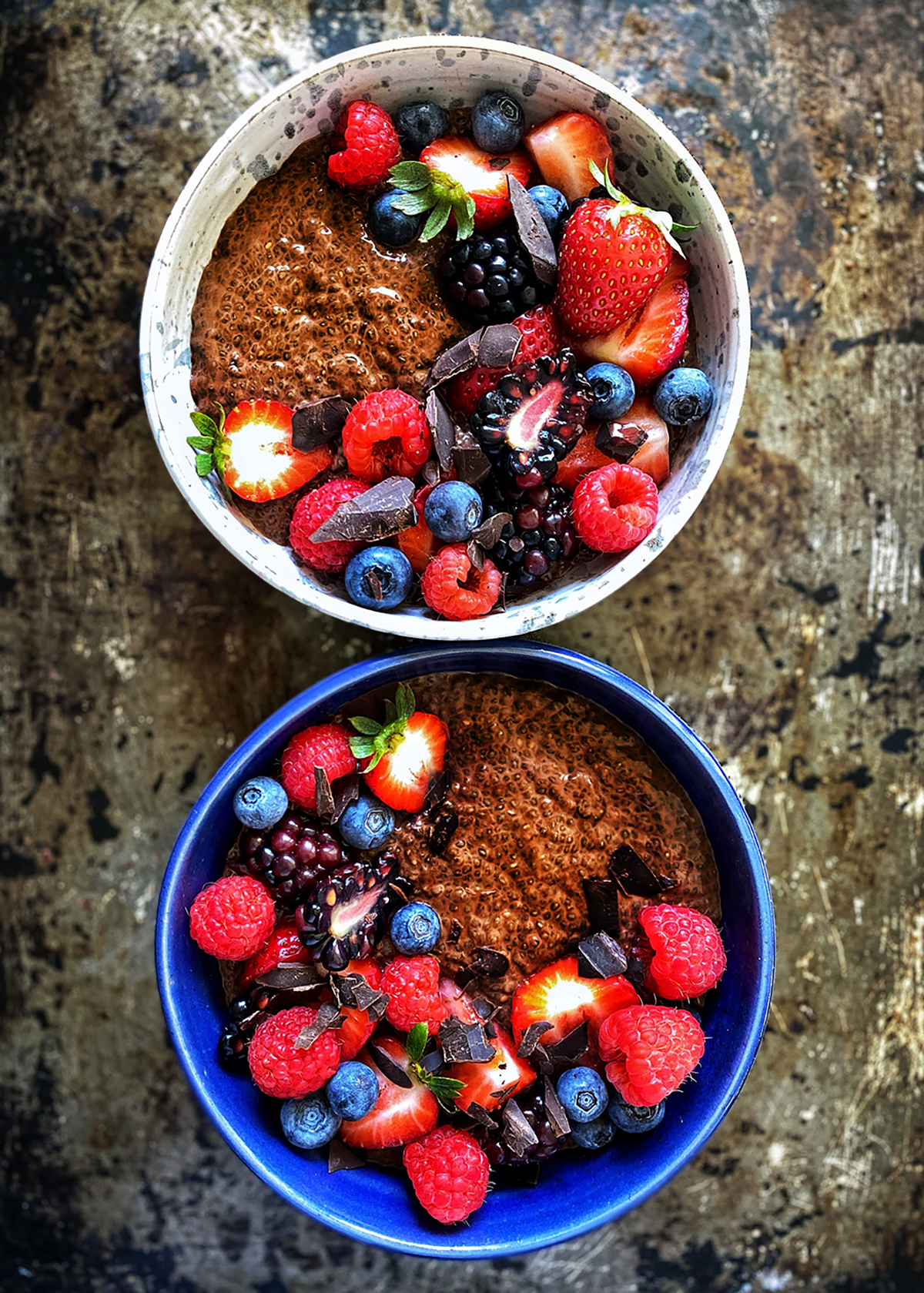 chocolate chia pudding in bowls with fresh berries