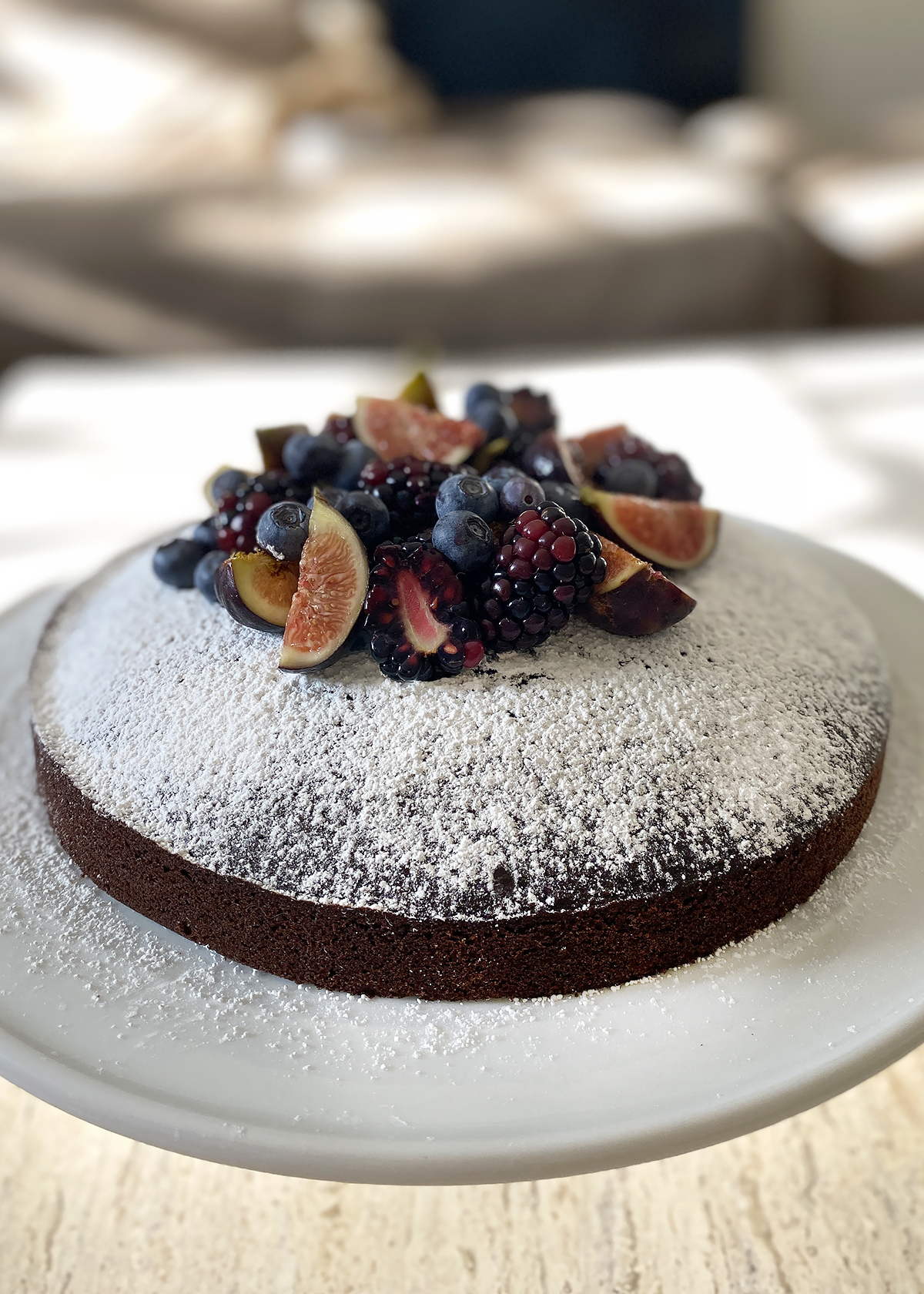 chocolate olive oil cake, confectioner's sugar with berries and figs