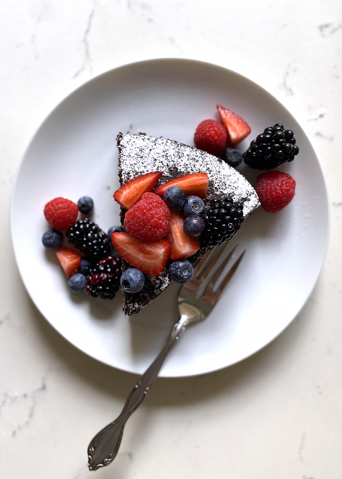 chocolate olive oil cake slice with berries