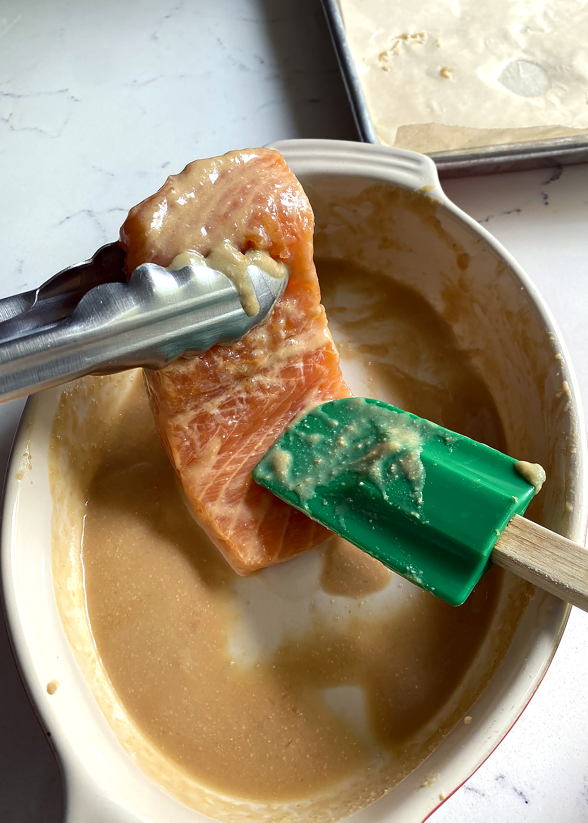 wiping miso marinade off salmon