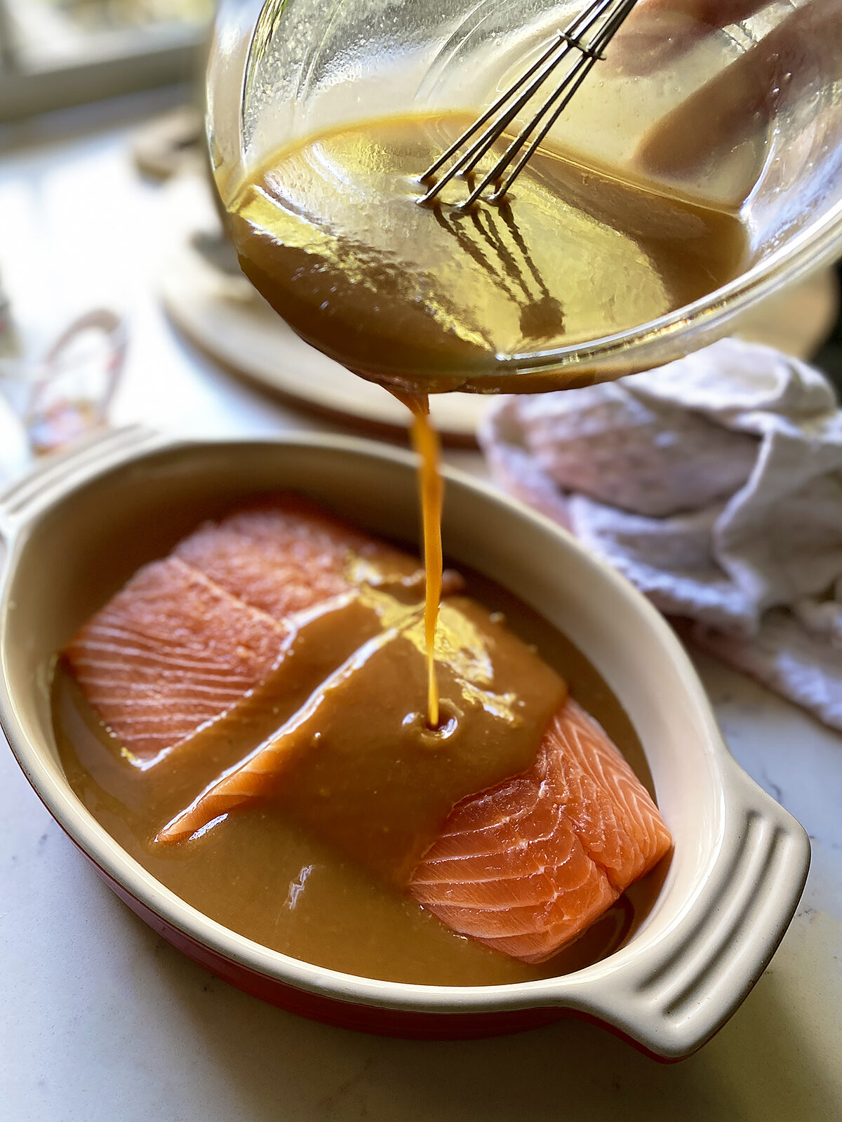 miso marinade pouring onto salmon