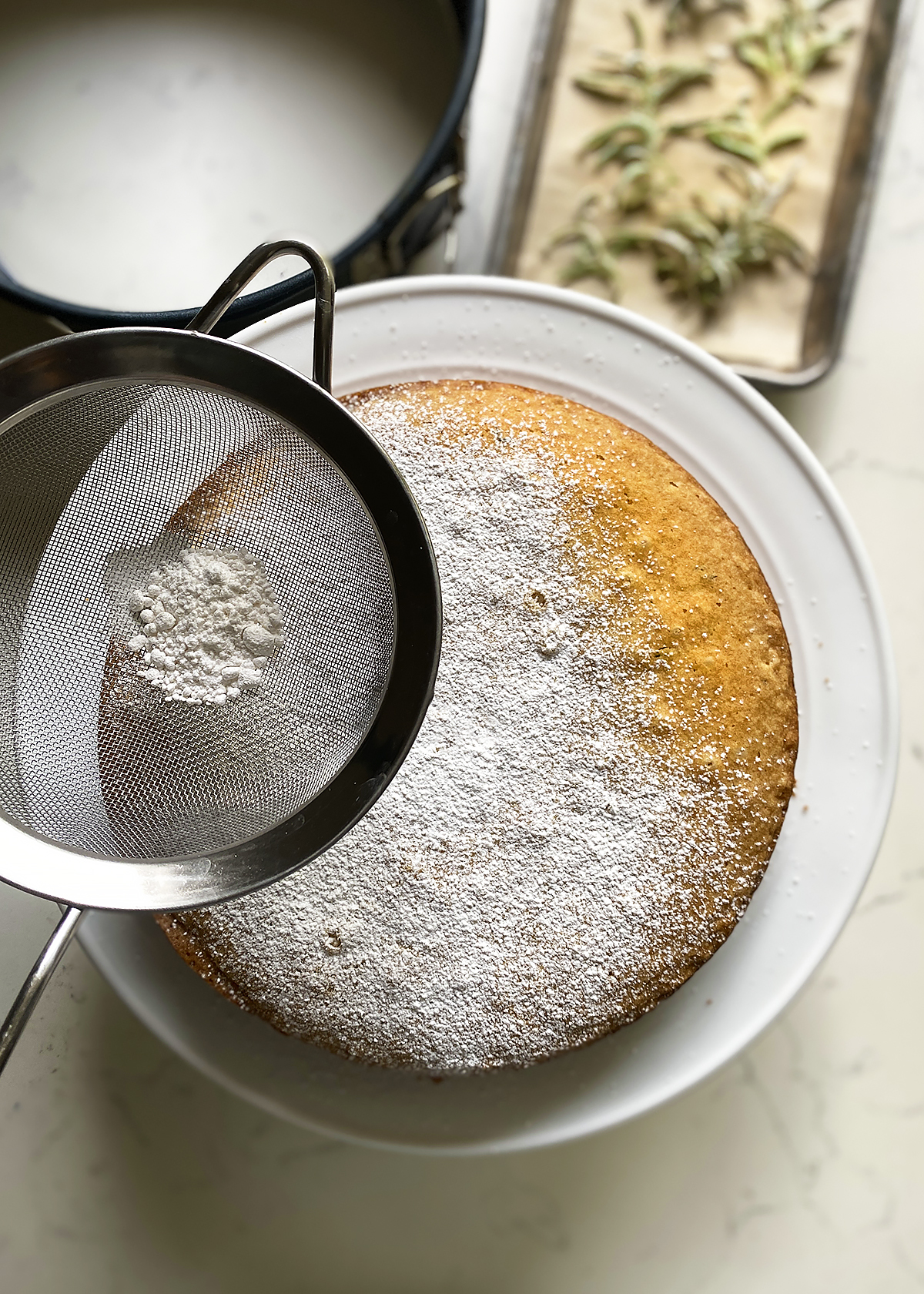 rosemary olive oil cake dusting with powdered sugar