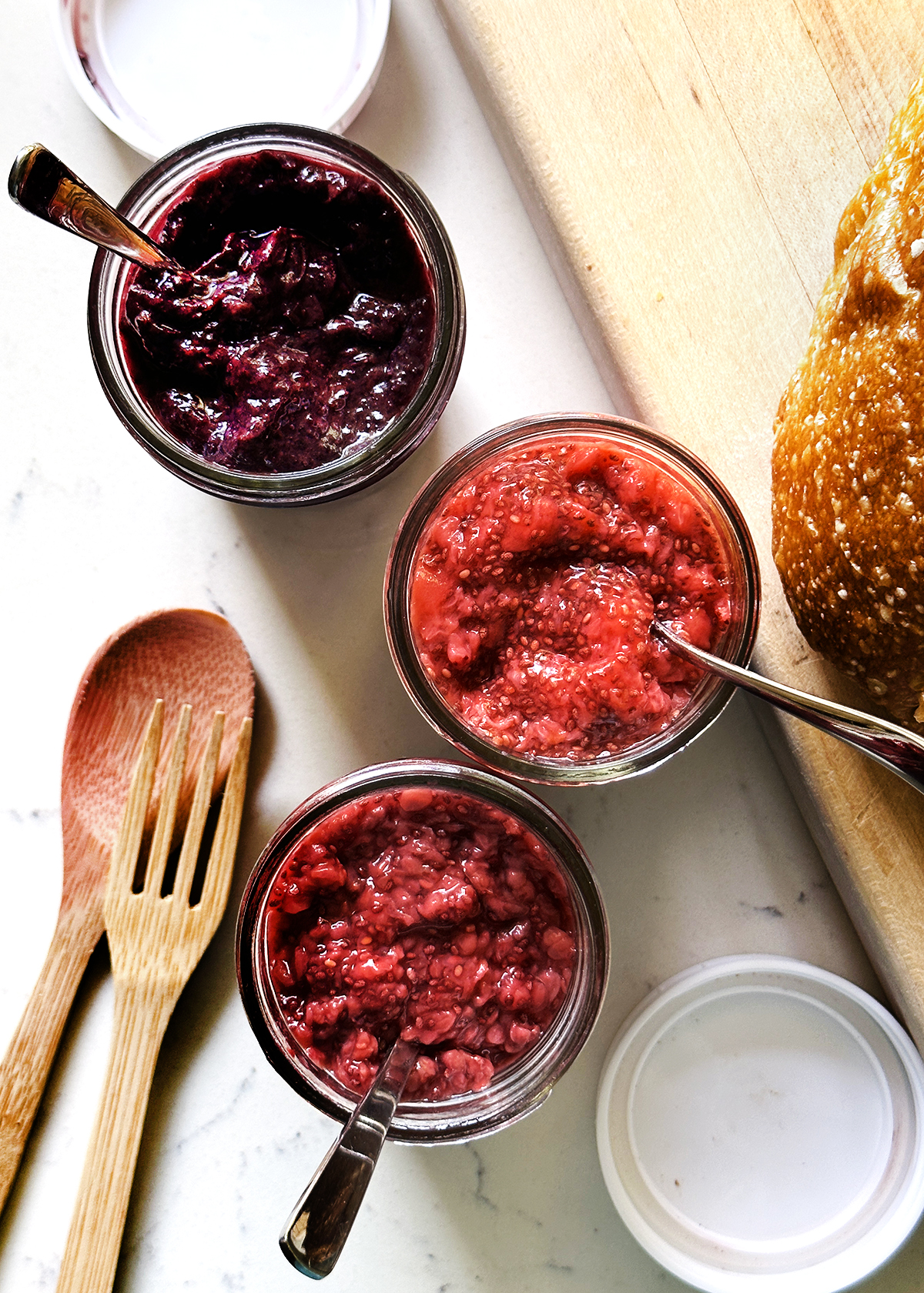 blueberry, strawberry, and raspberry chia jams in jars