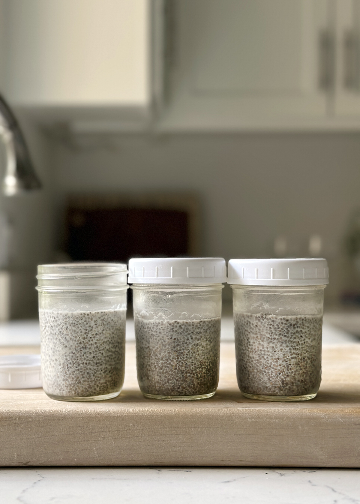 chia seed pudding mixed, in glass mason jars