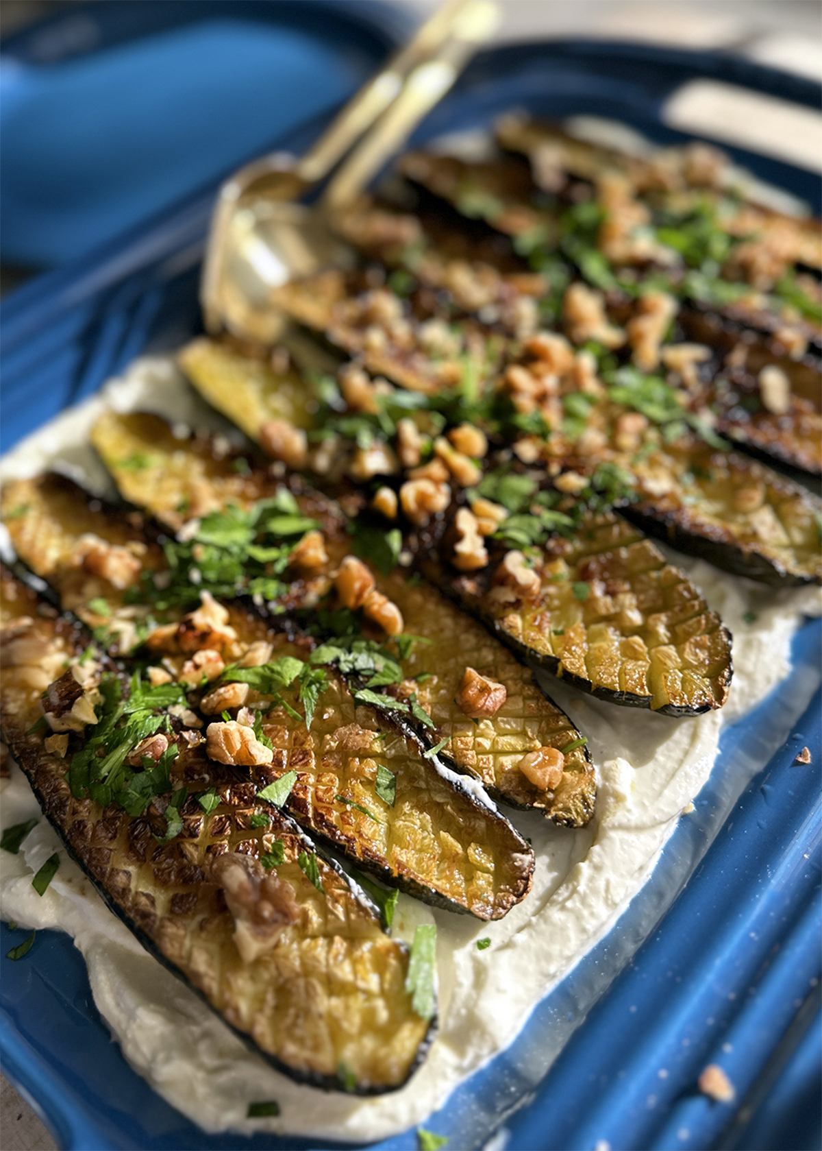 roasted zucchini with whipped feta and walnuts on platter