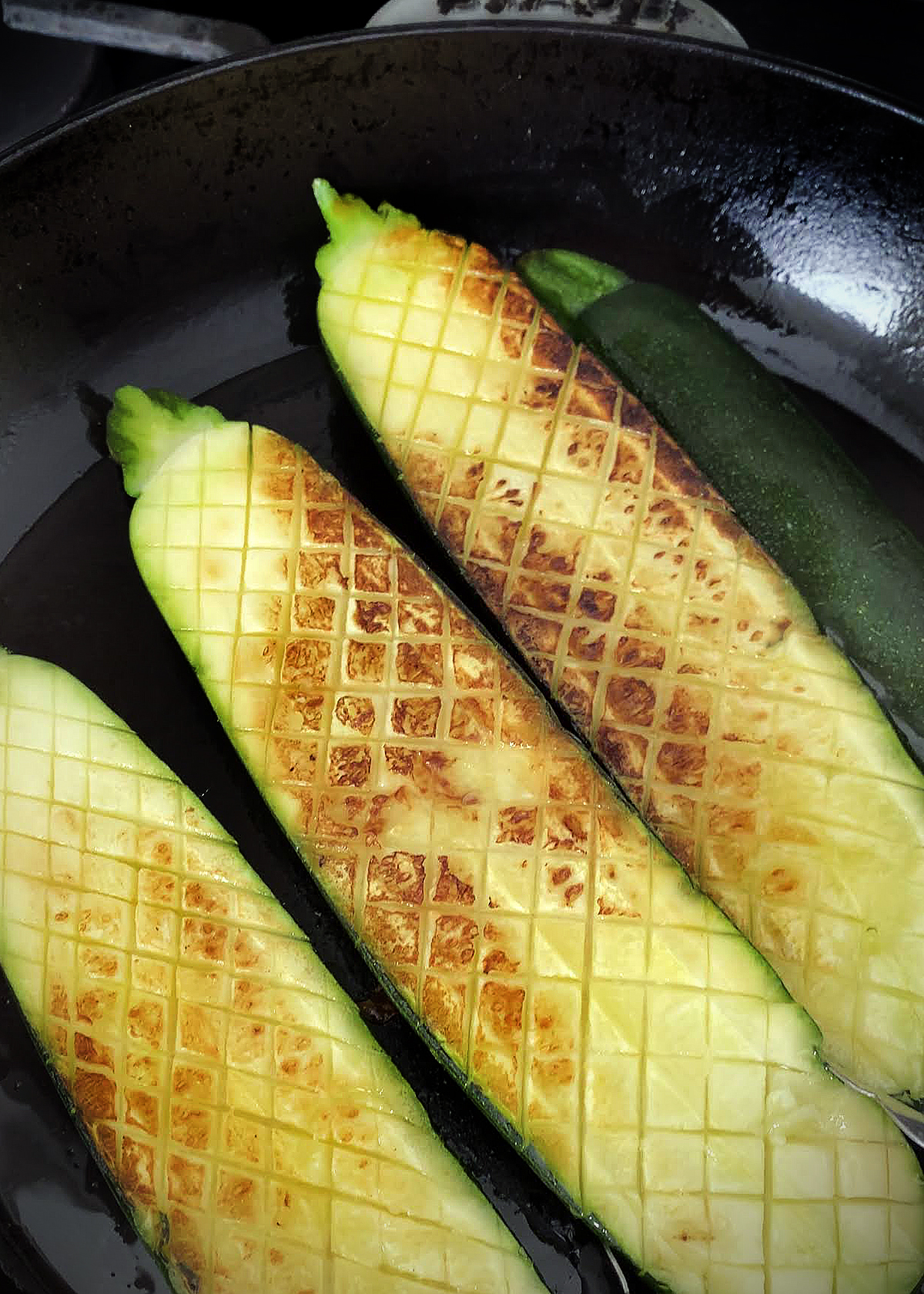 oven roasted zucchini sliced lengthwise, and cut thomas keller style, in cast iron skillet