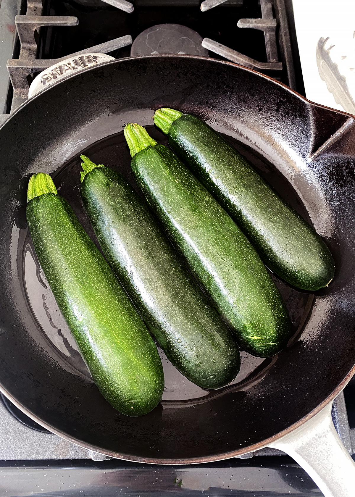 oven roasted zucchini sliced lengthwise, placed cut-side down in cast iron skillet