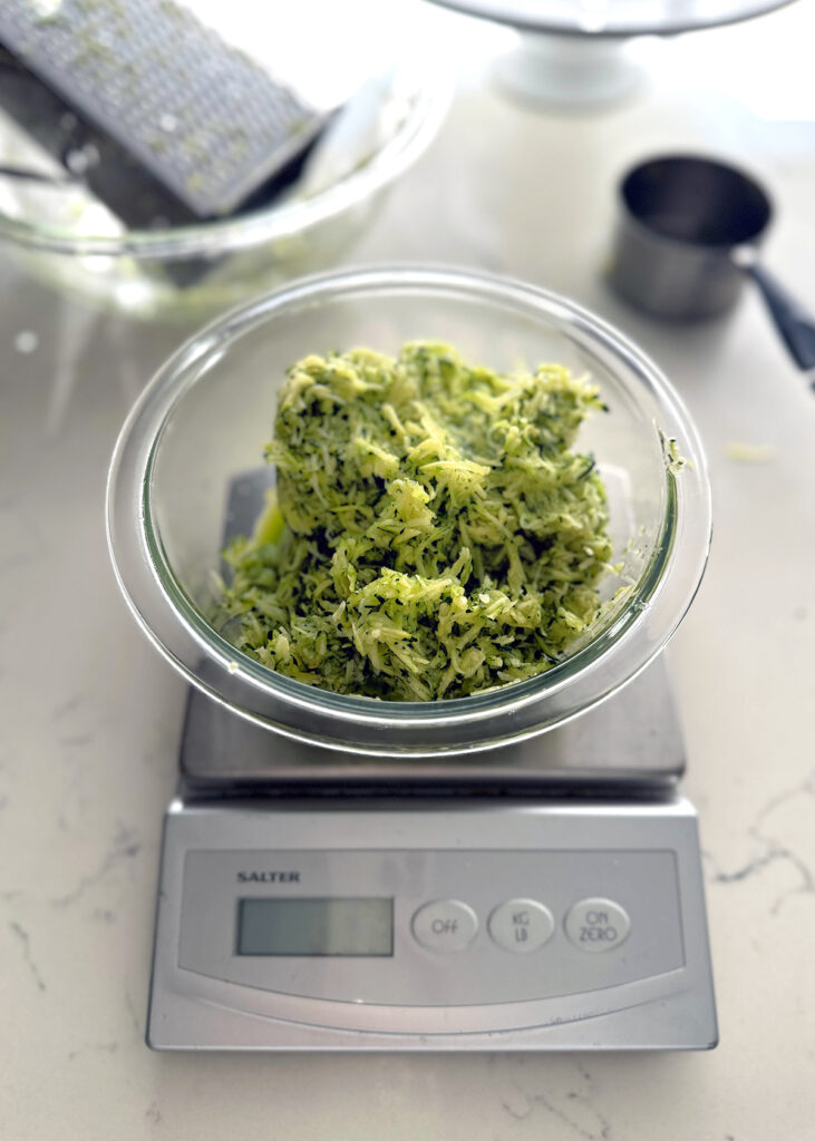 shredded zucchini in glass bowl on scale