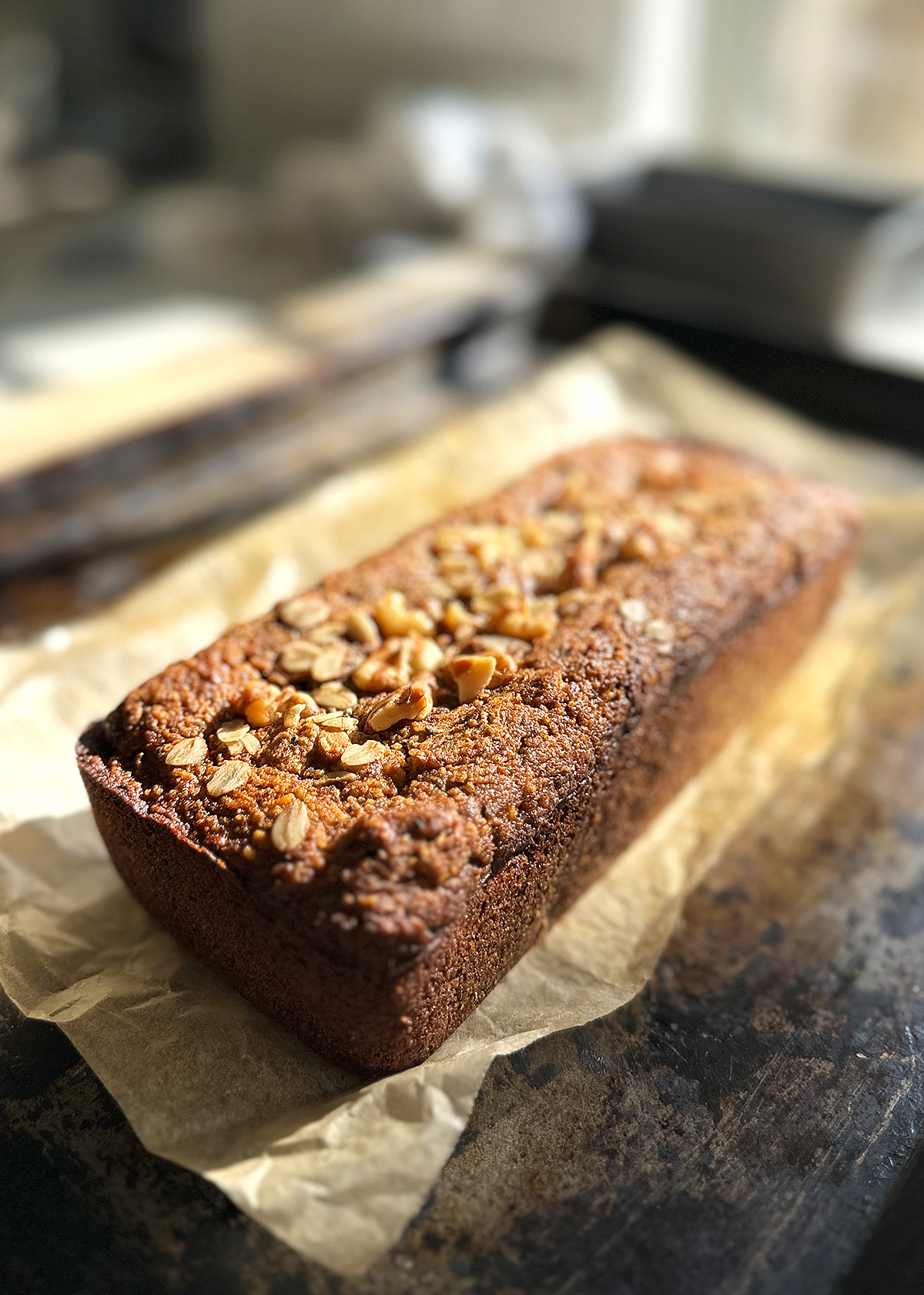 zucchini bread loaf with oat flour and walnuts, baked, cooling