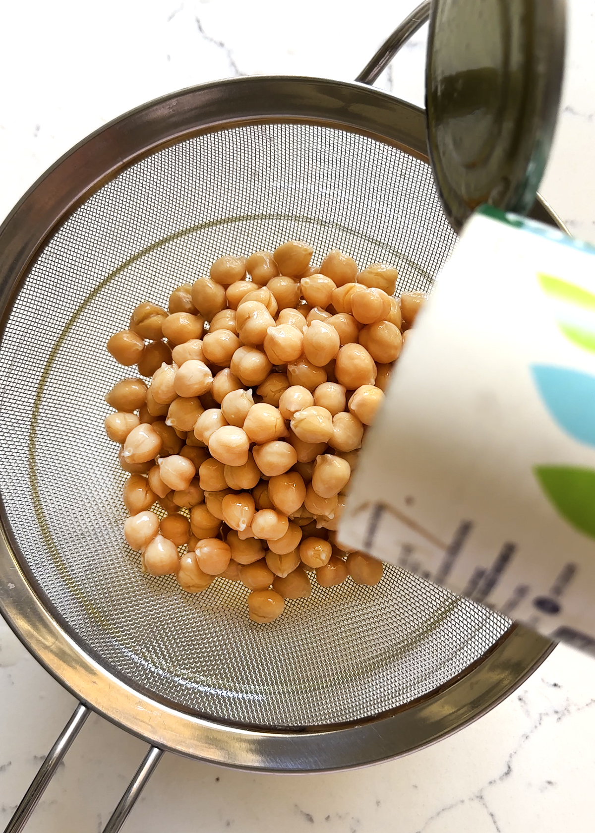 canned chickpeas draining in mesh sieve