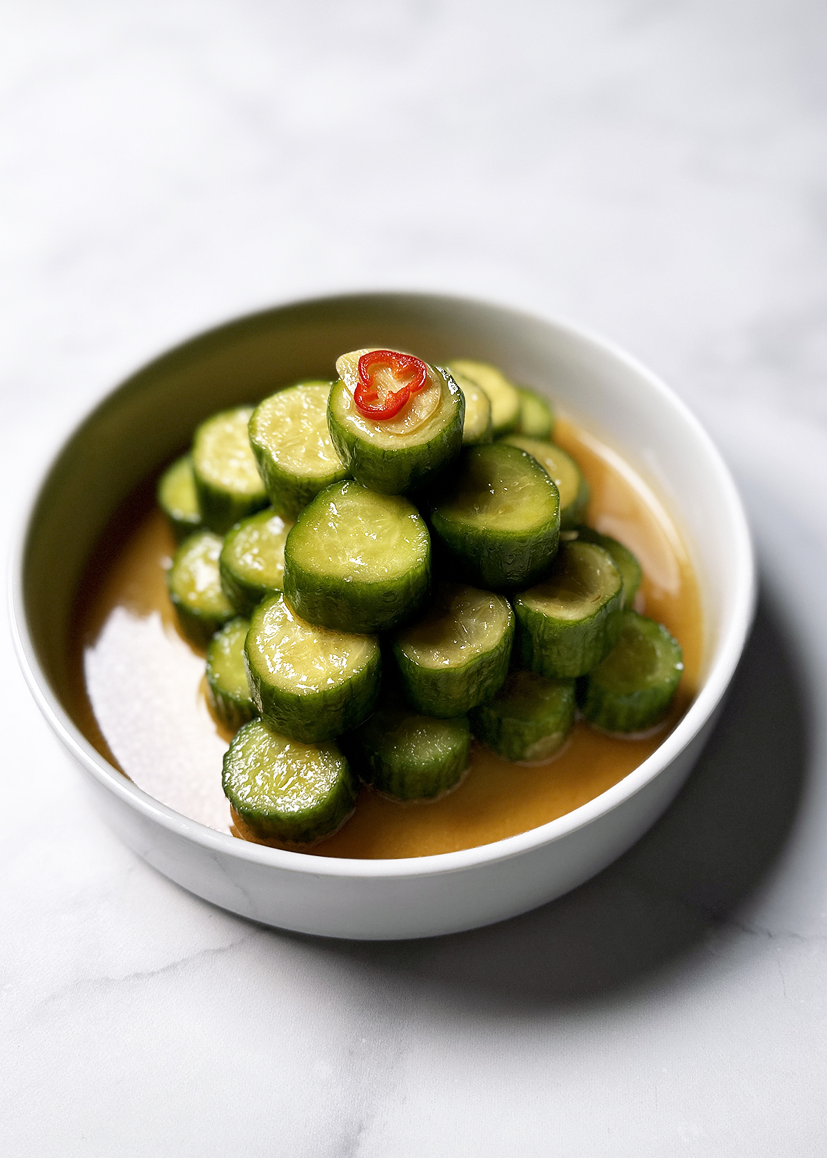 spicy cucumbers din tai fung style stacked in bowl