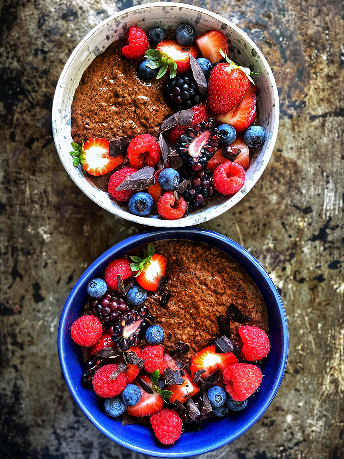 chocolate chia pudding in bowls with fresh berries