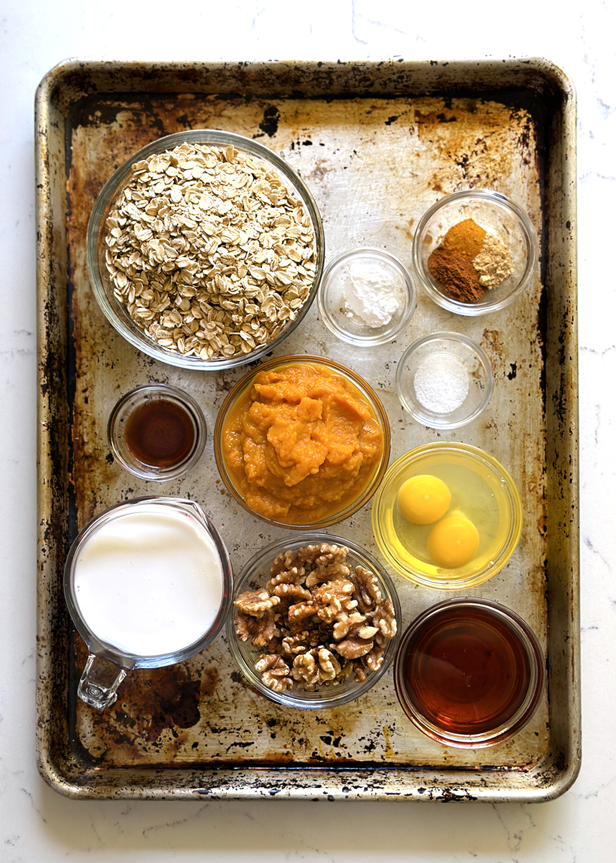 pumpkin spice baked oatmeal ingredients, measured in bowls