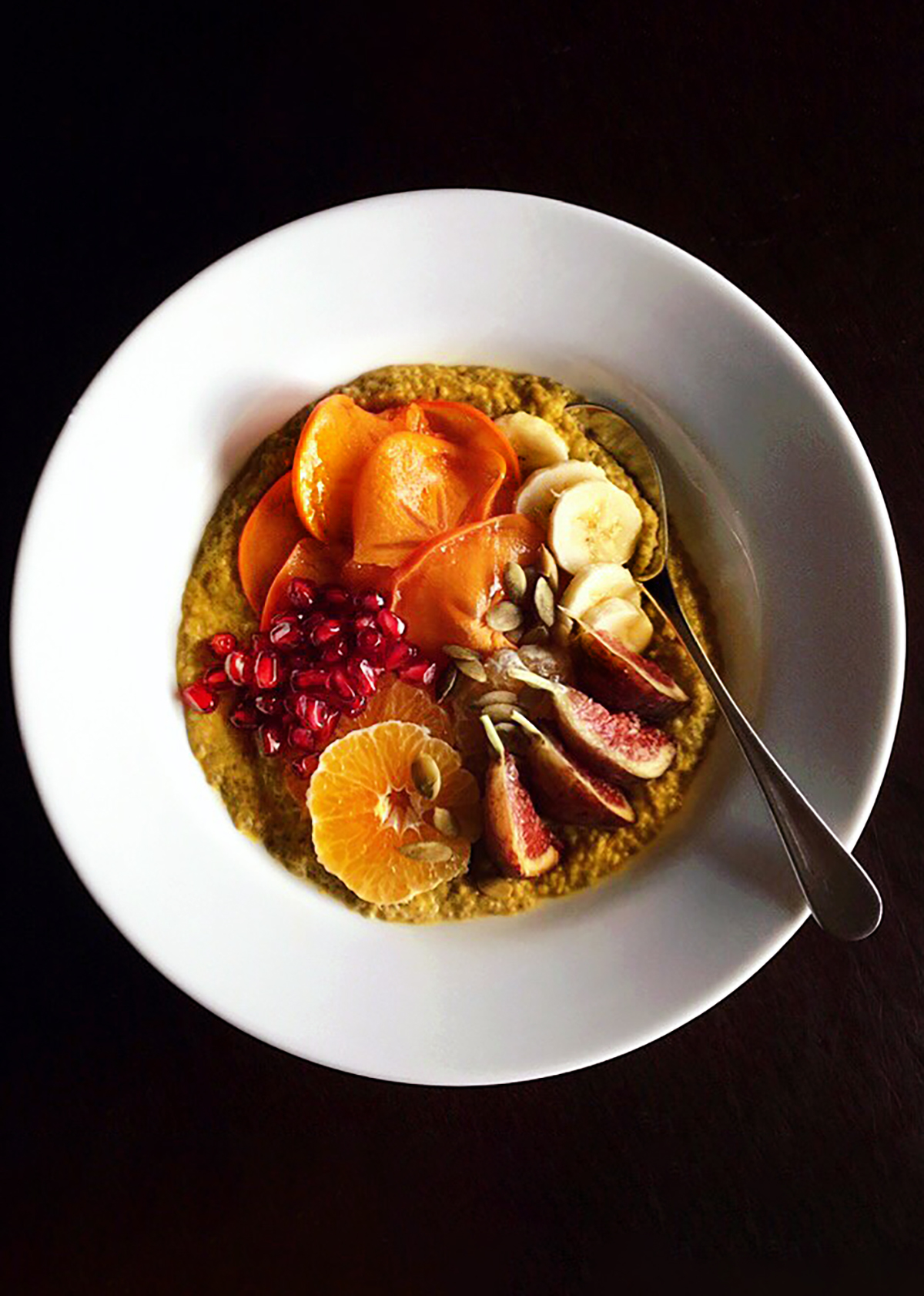 pumpkin spice chia seed pudding in white bowl with fruit toppings