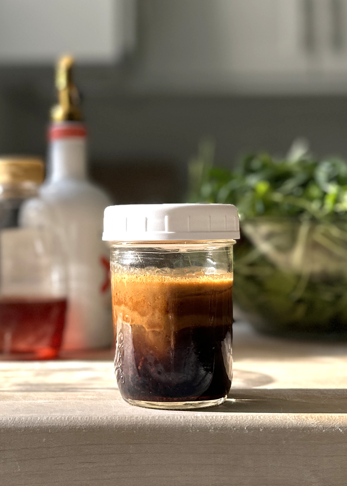 hot honey balsamic vinaigrette dressing shaken in mason jar