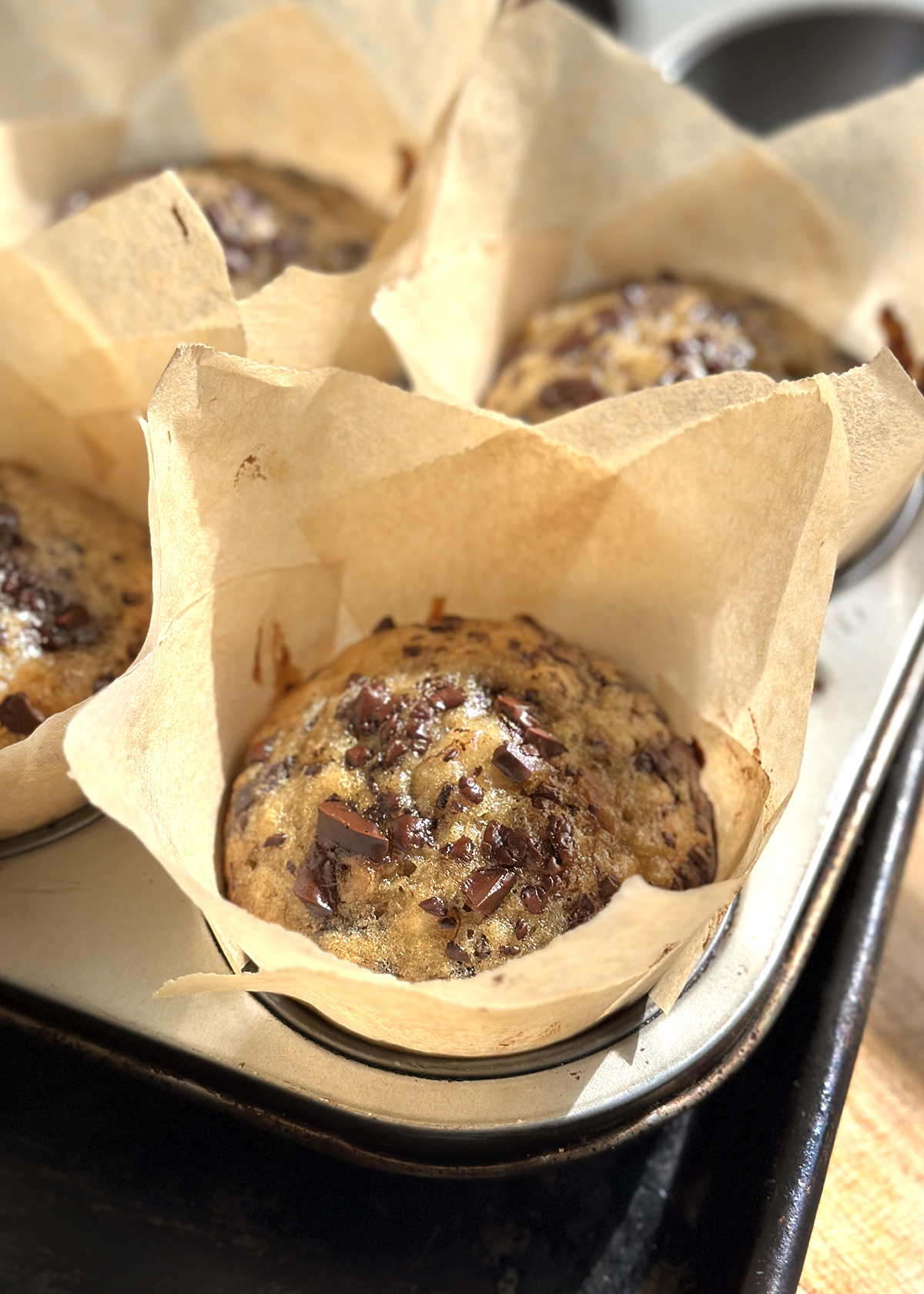 chocolate chip banana bread muffins in paper liner cups