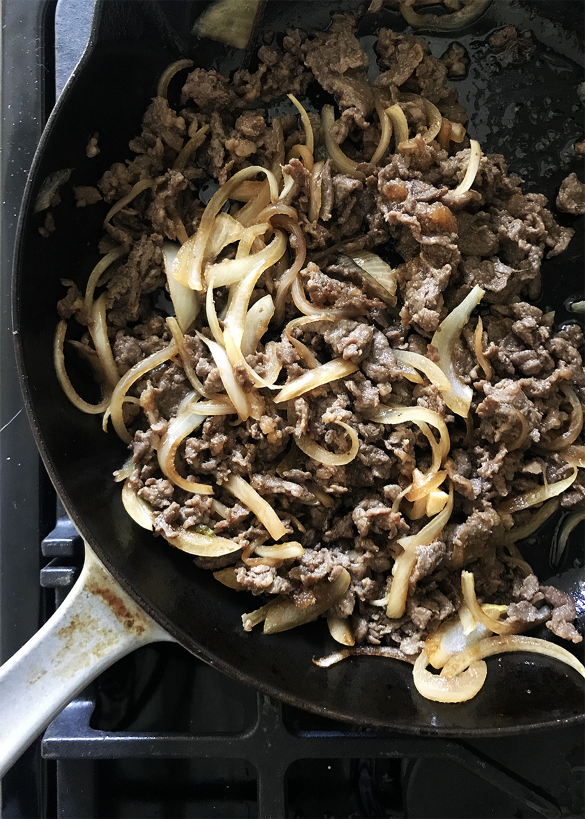 korean bbq beef bulgogi in cast iron skillet on stovetop