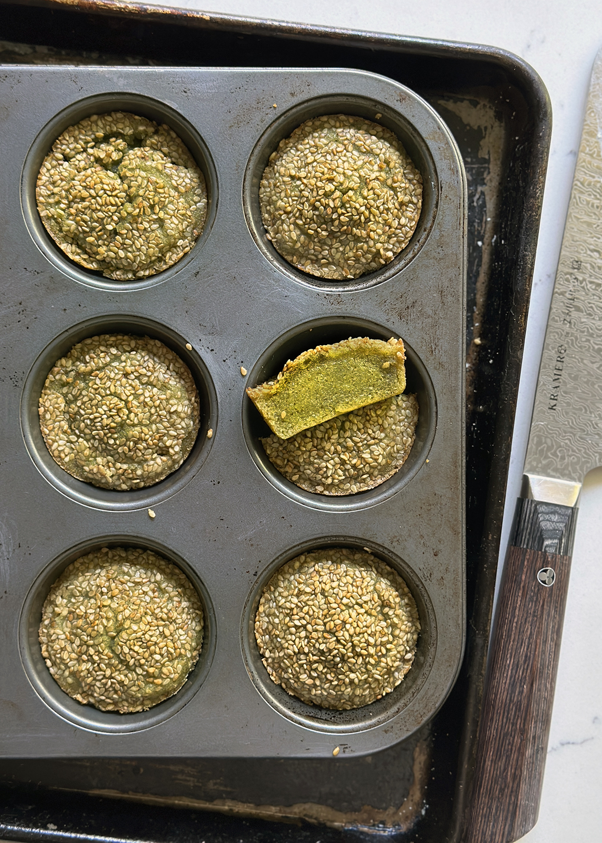 matcha butter mochi muffins with toasted sesame in tin