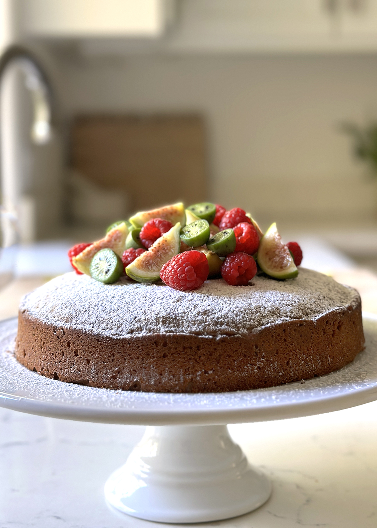 matcha olive oil cake on cakestand